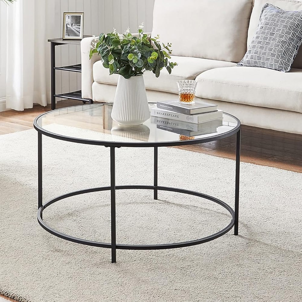 Runt soffbord med glasskiva och svart stålram